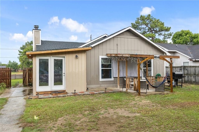 3374 Legion Rd, Hope Mills, NC 28348 - back of house with a chimney, roof with shingles, and a patio
