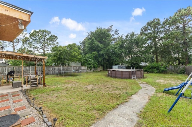 3374 Legion Rd, Hope Mills, NC 28348 - fenced backyard with a trampoline and a patio area