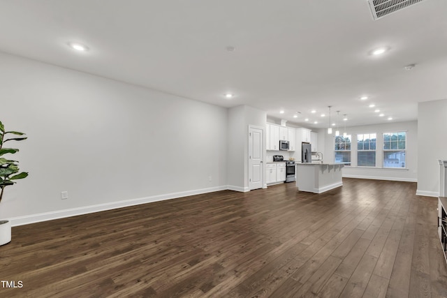 2849 Dallas Valley Ln, Apex, NC 27502 - unfurnished living room featuring dark wood finished floors and recessed lighting