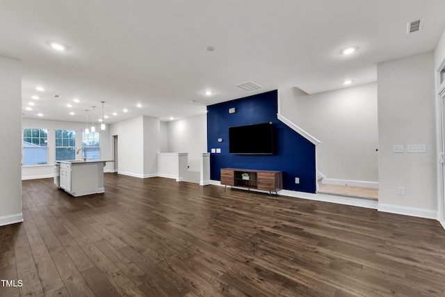 2849 Dallas Valley Ln, Apex, NC 27502 - unfurnished living room featuring dark wood-style floors and recessed lighting