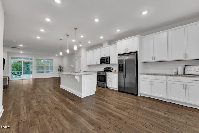 2849 Dallas Valley Ln, Apex, NC 27502 - kitchen featuring stainless steel appliances, dark wood-style floors, white cabinets, a kitchen bar, and a kitchen island with sink