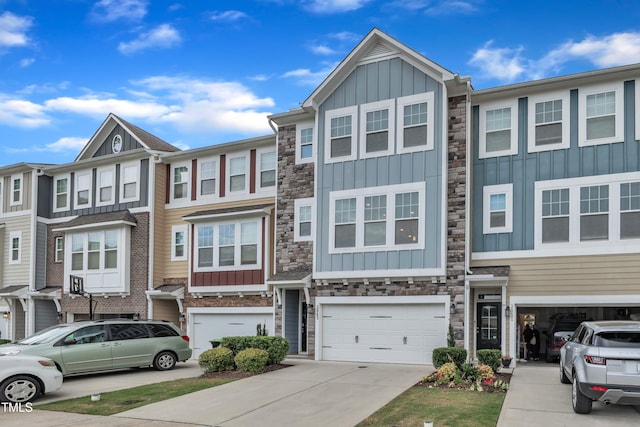 2849 Dallas Valley Ln, Apex, NC 27502 - townhome / multi-family property with board and batten siding, stone siding, driveway, and an attached garage