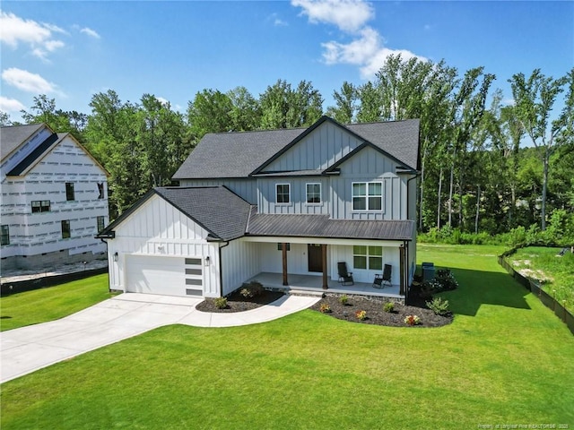 412 Stable Ct, Linden, NC 28356 - modern farmhouse featuring board and batten siding, covered porch, a front lawn, and an attached garage