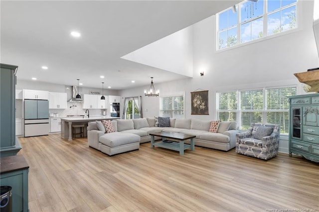 412 Stable Ct, Linden, NC 28356 - living room with a chandelier, light wood-style flooring, recessed lighting, and a towering ceiling
