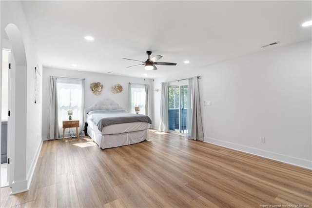 412 Stable Ct, Linden, NC 28356 - bedroom with access to exterior, arched walkways, light wood finished floors, recessed lighting, and ceiling fan