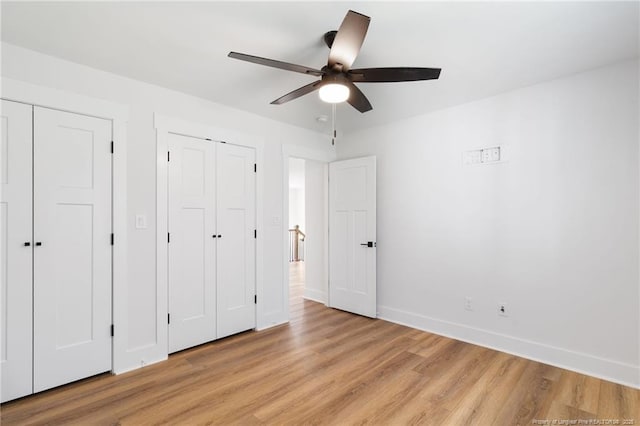 412 Stable Ct, Linden, NC 28356 - unfurnished bedroom with light wood-style flooring, multiple closets, and ceiling fan