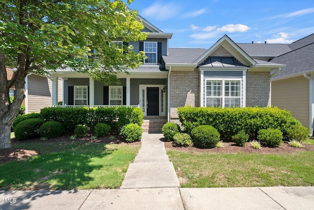 308 Minton Valley Ln, Cary, NC 27519 - view of front of property featuring brick siding, a front yard, and covered porch
