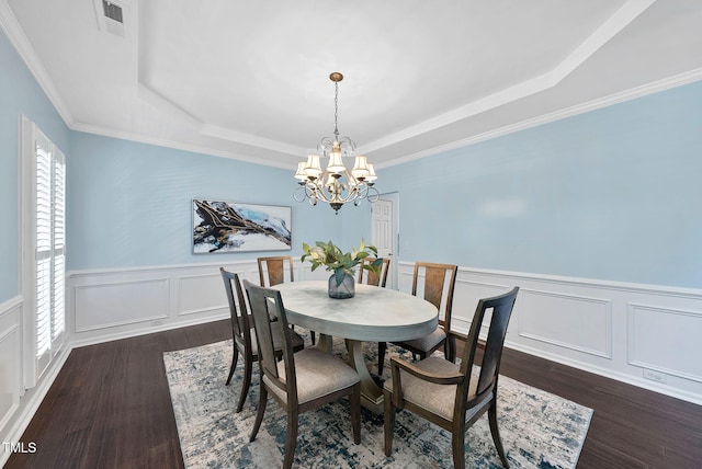 308 Minton Valley Ln, Cary, NC 27519 - dining area featuring a raised ceiling, a chandelier, dark wood finished floors, a decorative wall, and a wainscoted wall