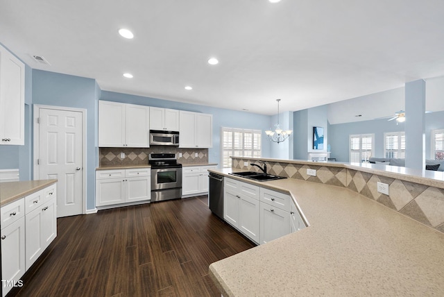 308 Minton Valley Ln, Cary, NC 27519 - kitchen with appliances with stainless steel finishes, a chandelier, healthy amount of natural light, backsplash, and recessed lighting