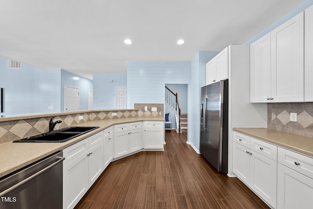 308 Minton Valley Ln, Cary, NC 27519 - kitchen with stainless steel appliances, light countertops, tasteful backsplash, white cabinetry, and recessed lighting