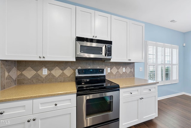 308 Minton Valley Ln, Cary, NC 27519 - kitchen with stainless steel appliances, dark wood finished floors, white cabinets, and tasteful backsplash