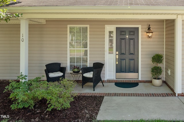 10 N Berrymeadow Ln, Durham, NC 27703 - view of exterior entry with a porch and a shingled roof