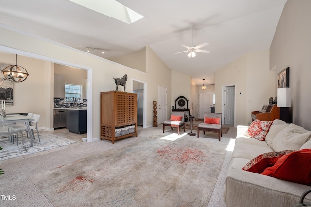 10 N Berrymeadow Ln, Durham, NC 27703 - living room featuring light colored carpet, a chandelier, high vaulted ceiling, a skylight, and ceiling fan