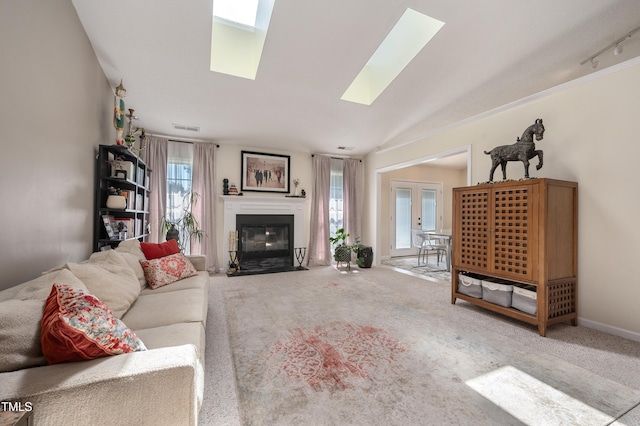 10 N Berrymeadow Ln, Durham, NC 27703 - carpeted living area featuring a skylight and a fireplace with flush hearth