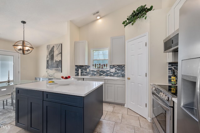 10 N Berrymeadow Ln, Durham, NC 27703 - kitchen with appliances with stainless steel finishes, tasteful backsplash, lofted ceiling, light countertops, and decorative light fixtures