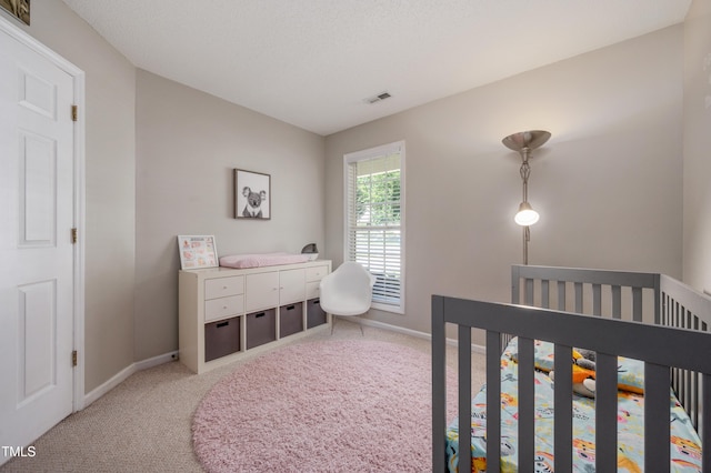 10 N Berrymeadow Ln, Durham, NC 27703 - bedroom featuring light colored carpet and a crib