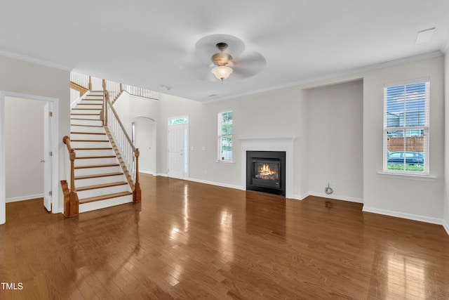 2801 Casona Way, Raleigh, NC 27616 - unfurnished living room with a ceiling fan, wood finished floors, stairway, ornamental molding, and a glass covered fireplace