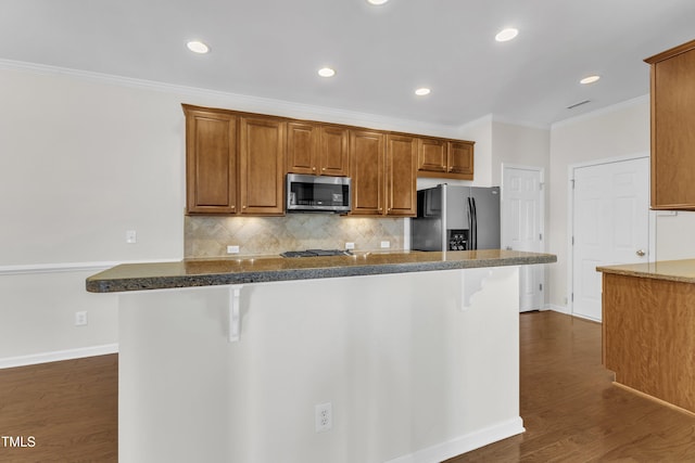 2801 Casona Way, Raleigh, NC 27616 - kitchen with appliances with stainless steel finishes, a kitchen breakfast bar, ornamental molding, backsplash, and dark wood finished floors