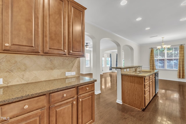 2801 Casona Way, Raleigh, NC 27616 - kitchen with plenty of natural light, dark wood finished floors, light stone counters, tasteful backsplash, and crown molding