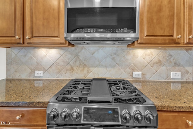 2801 Casona Way, Raleigh, NC 27616 - kitchen featuring appliances with stainless steel finishes, brown cabinets, stone counters, and tasteful backsplash
