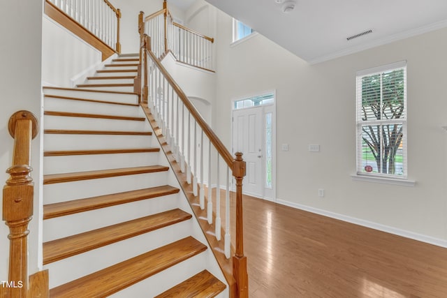 2801 Casona Way, Raleigh, NC 27616 - staircase featuring wood finished floors and crown molding