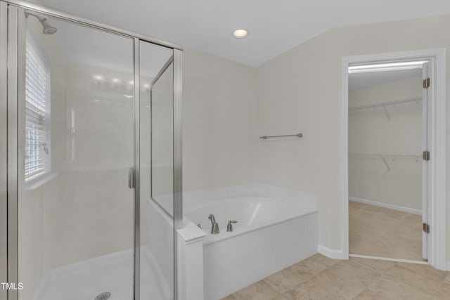 2801 Casona Way, Raleigh, NC 27616 - full bathroom featuring a stall shower, a bath, a walk in closet, tile patterned floors, and healthy amount of natural light