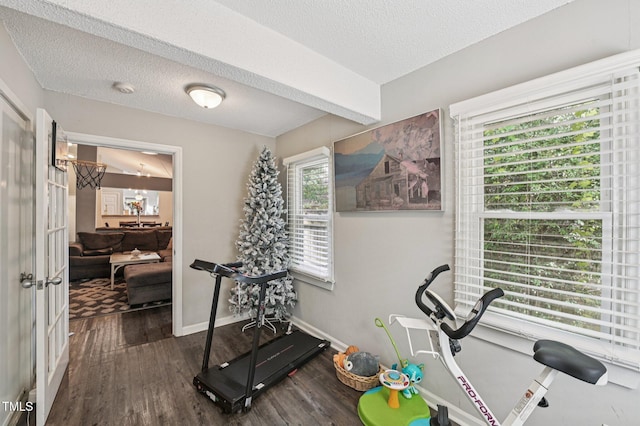 307 Wax Myrtle Ct, Cary, NC 27513 - workout area featuring wood finished floors, healthy amount of natural light, and a textured ceiling