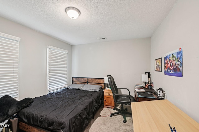 307 Wax Myrtle Ct, Cary, NC 27513 - bedroom with light carpet, a textured ceiling, and a desk