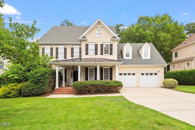 5001 Sears Farm Rd, Cary, NC 27519 - view of front facade featuring covered porch, an attached garage, a front lawn, driveway, and a standing seam roof
