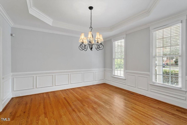 5001 Sears Farm Rd, Cary, NC 27519 - spare room with a chandelier, a raised ceiling, light wood-style floors, wainscoting, and ornamental molding