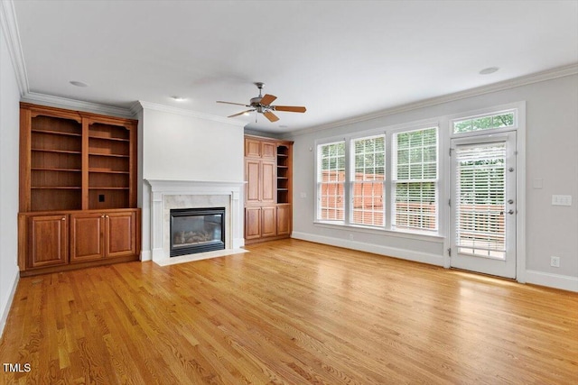 5001 Sears Farm Rd, Cary, NC 27519 - unfurnished living room featuring a premium fireplace, light wood-style flooring, crown molding, and a ceiling fan