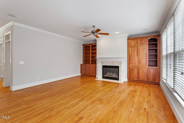 5001 Sears Farm Rd, Cary, NC 27519 - unfurnished living room with healthy amount of natural light, ceiling fan, light wood-style floors, ornamental molding, and a fireplace with flush hearth