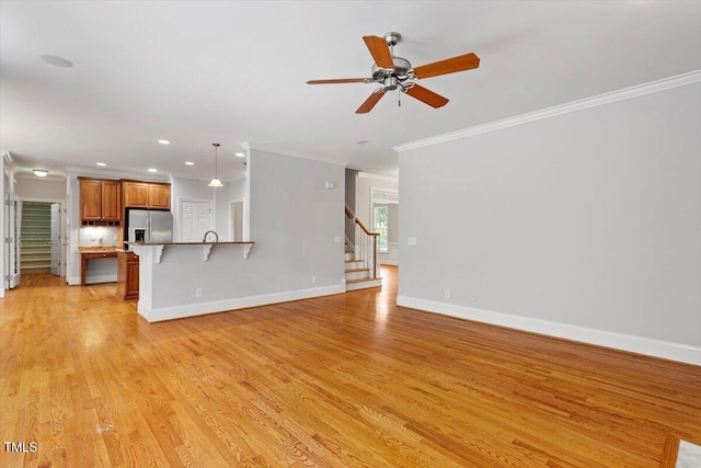 5001 Sears Farm Rd, Cary, NC 27519 - unfurnished living room featuring stairway, a ceiling fan, crown molding, light wood-type flooring, and recessed lighting