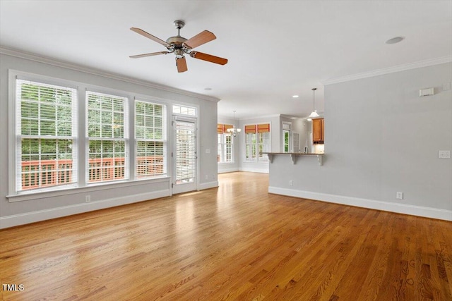 5001 Sears Farm Rd, Cary, NC 27519 - unfurnished living room featuring crown molding, light wood-style flooring, ceiling fan, and a chandelier