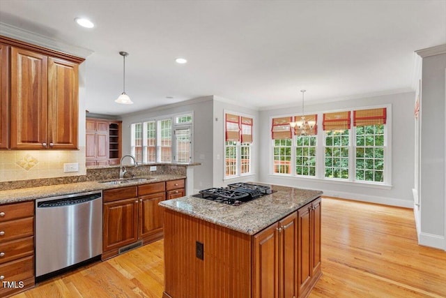 5001 Sears Farm Rd, Cary, NC 27519 - kitchen featuring dishwasher, gas cooktop, brown cabinets, light wood-style floors, and crown molding