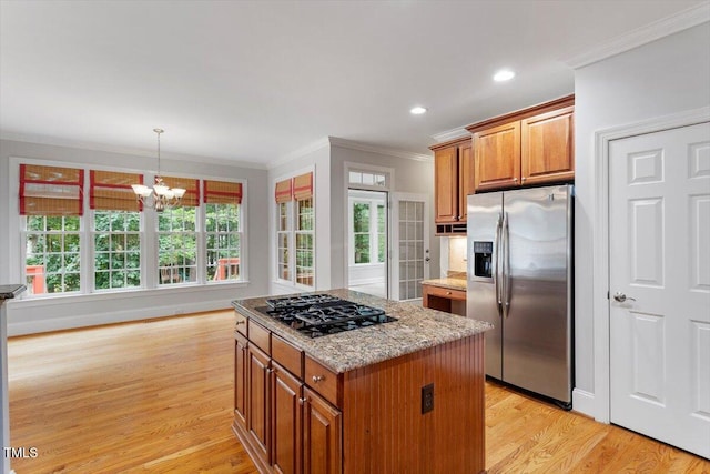 5001 Sears Farm Rd, Cary, NC 27519 - kitchen with stainless steel fridge with ice dispenser, black gas cooktop, crown molding, brown cabinets, and a chandelier