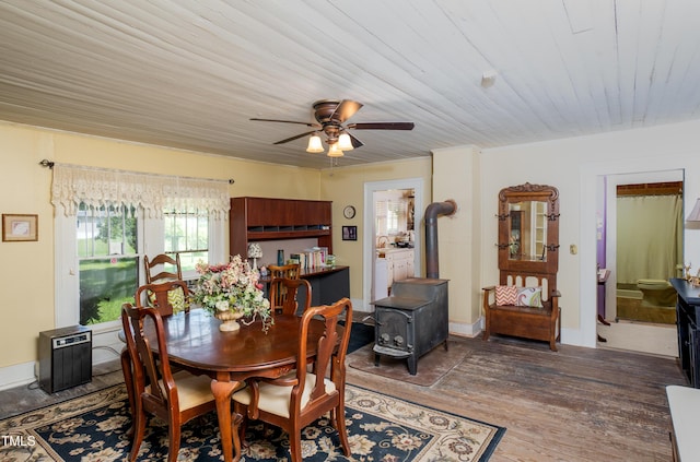7167 Adolph Rd, Bailey, NC 27807 - dining area with a wood stove, ceiling fan, and wood finished floors