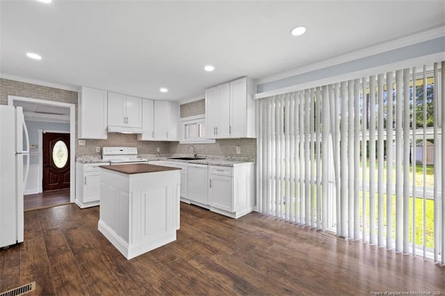 4209 Coventry Rd, Fayetteville, NC 28304 - kitchen featuring white appliances, under cabinet range hood, a kitchen island, dark wood finished floors, and crown molding