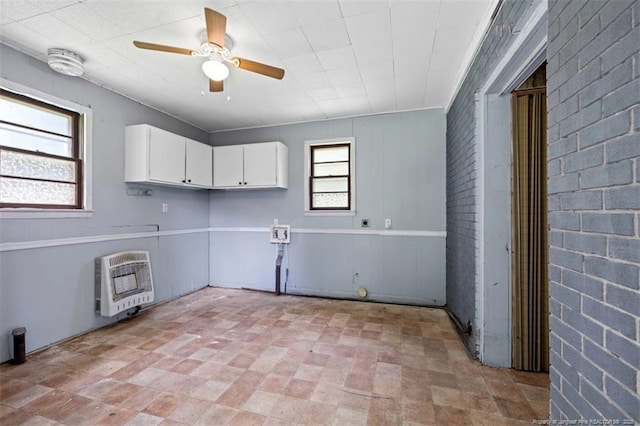 4209 Coventry Rd, Fayetteville, NC 28304 - laundry area with heating unit, cabinet space, and ceiling fan