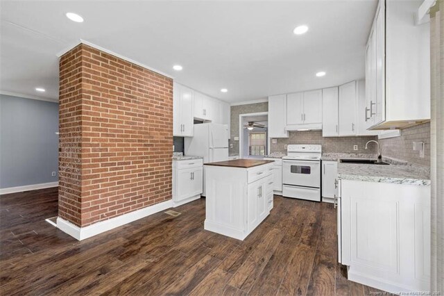 4209 Coventry Rd, Fayetteville, NC 28304 - kitchen featuring white appliances, dark wood-type flooring, crown molding, a center island, and white cabinets