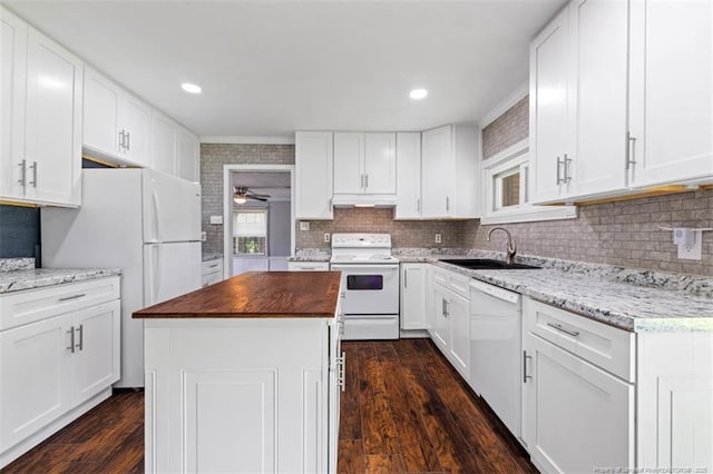 4209 Coventry Rd, Fayetteville, NC 28304 - kitchen featuring white appliances, wooden counters, dark wood-style flooring, a kitchen island, and a ceiling fan