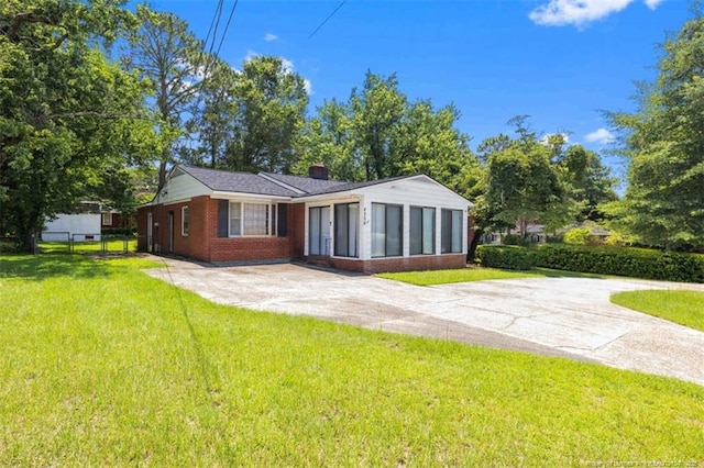 4209 Coventry Rd, Fayetteville, NC 28304 - rear view of house featuring a sunroom, a chimney, and brick siding