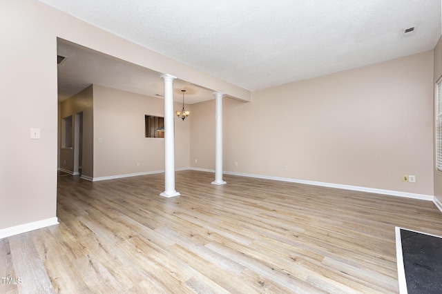 424 Nomar, Raleigh, NC 27610 - unfurnished living room featuring decorative columns and light wood-style floors