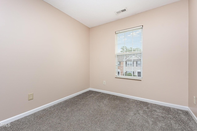 424 Nomar, Raleigh, NC 27610 - empty room featuring dark colored carpet and baseboards