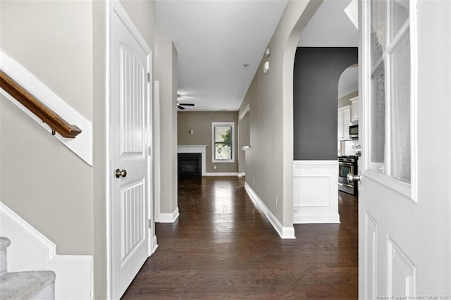 17 Tanawha Ct, Spring Lake, NC 28390 - entryway featuring dark wood-style flooring, arched walkways, a fireplace, ceiling fan, and stairs