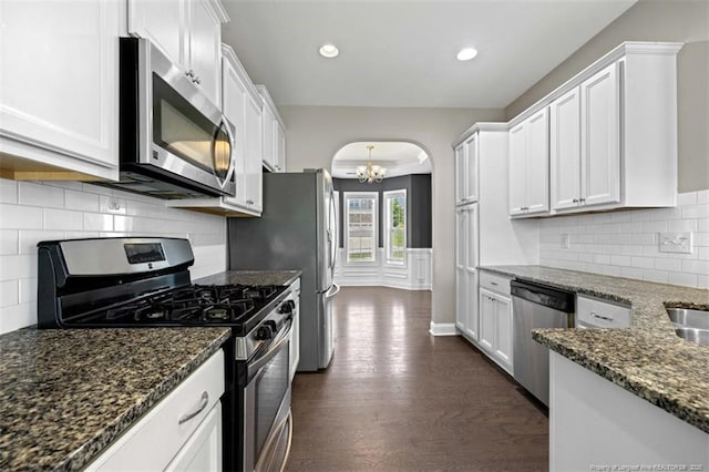 17 Tanawha Ct, Spring Lake, NC 28390 - kitchen with stainless steel appliances, arched walkways, dark wood-style flooring, white cabinets, and recessed lighting