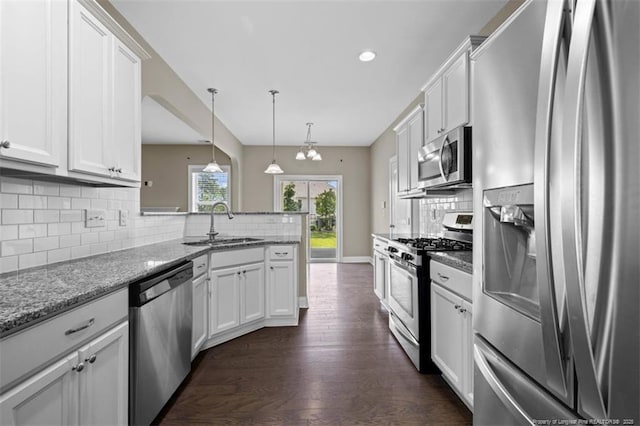 17 Tanawha Ct, Spring Lake, NC 28390 - kitchen with appliances with stainless steel finishes, a peninsula, white cabinetry, decorative backsplash, and recessed lighting