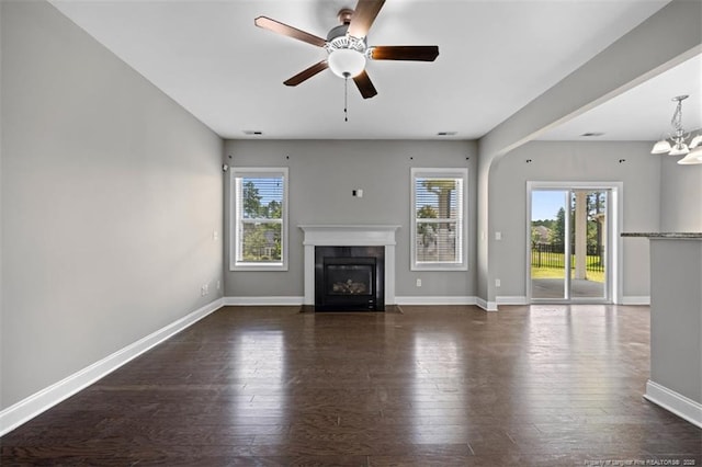 17 Tanawha Ct, Spring Lake, NC 28390 - unfurnished living room with healthy amount of natural light, a fireplace with flush hearth, ceiling fan, and dark wood-type flooring