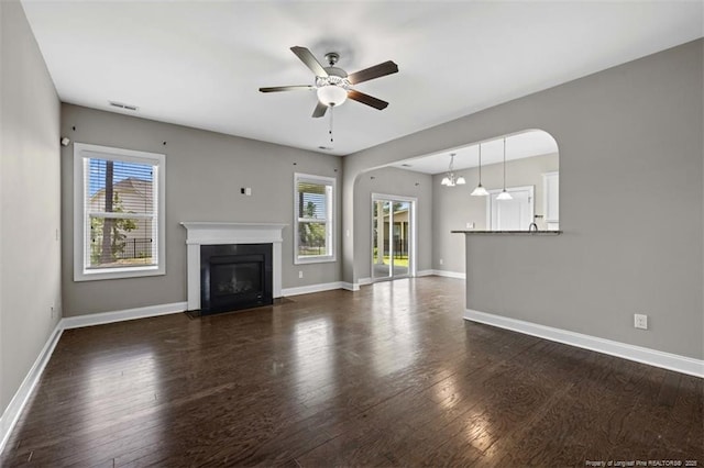 17 Tanawha Ct, Spring Lake, NC 28390 - unfurnished living room featuring plenty of natural light, a ceiling fan, a fireplace with flush hearth, and wood finished floors