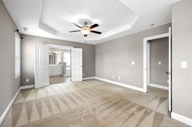 17 Tanawha Ct, Spring Lake, NC 28390 - unfurnished bedroom featuring a tray ceiling, light carpet, and multiple windows